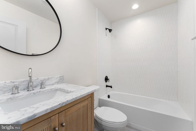 full bathroom with tiled shower / bath, vanity, and toilet