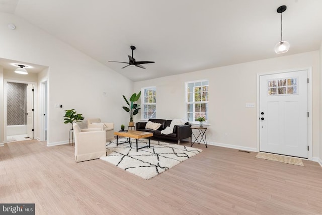 living room featuring light hardwood / wood-style floors, ceiling fan, and lofted ceiling