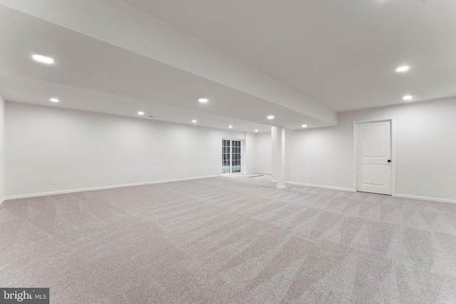 basement featuring light carpet