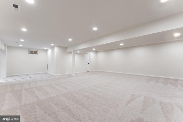 basement featuring light carpet