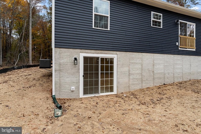 view of side of home with central AC