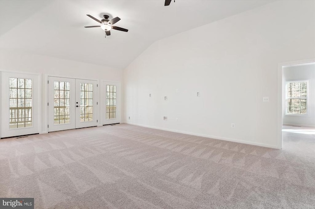 unfurnished living room with plenty of natural light, ceiling fan, and light colored carpet