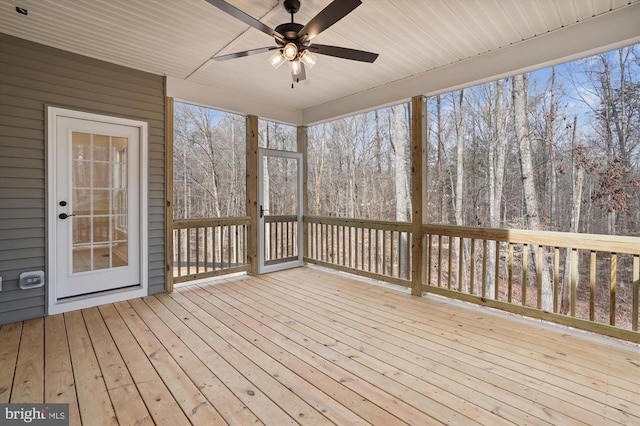 unfurnished sunroom with ceiling fan