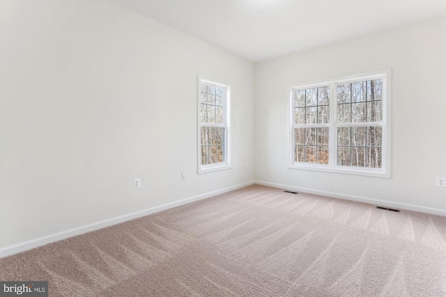 unfurnished room featuring carpet