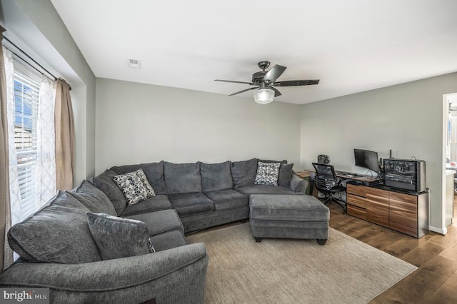 living room featuring hardwood / wood-style flooring and ceiling fan