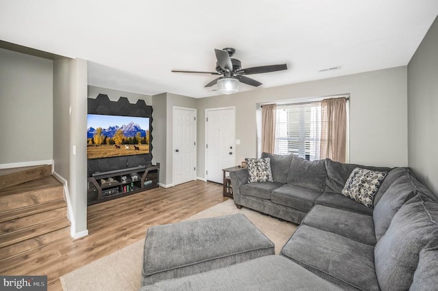 living room with ceiling fan and light hardwood / wood-style flooring