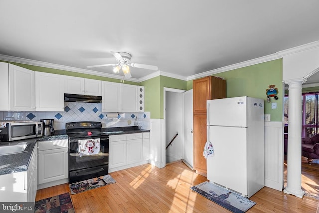 kitchen with decorative columns, black range with electric stovetop, white cabinets, and white fridge