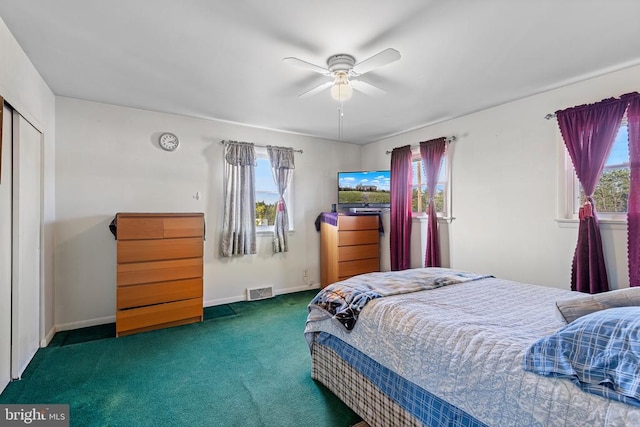 bedroom featuring ceiling fan, dark carpet, a closet, and multiple windows