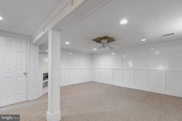 basement featuring light colored carpet and ceiling fan