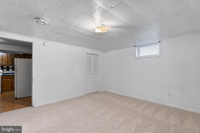 spare room featuring light colored carpet