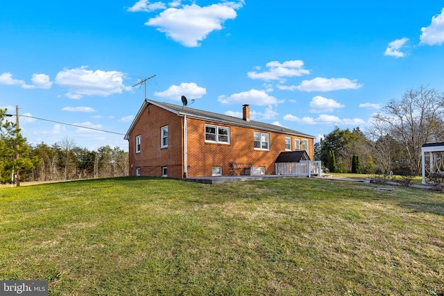 rear view of property featuring a lawn