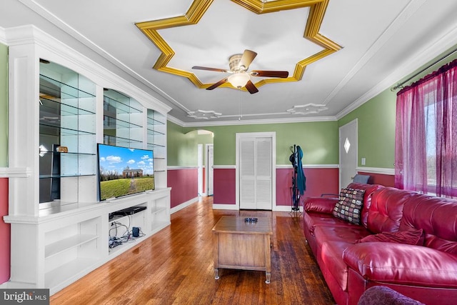 living room with ceiling fan, dark wood-type flooring, and ornamental molding