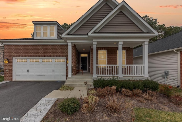 craftsman house featuring a porch and a garage