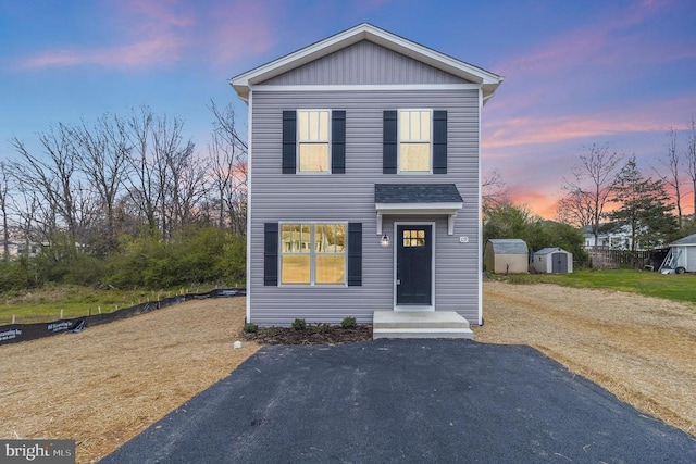 front facade with a storage shed