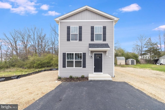 front of property featuring a shed