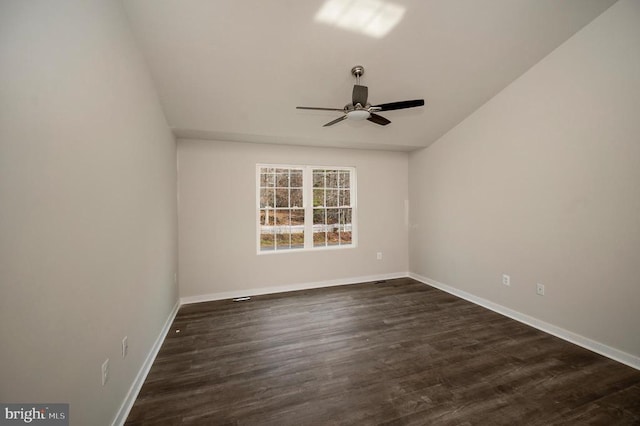 empty room featuring ceiling fan and dark hardwood / wood-style flooring