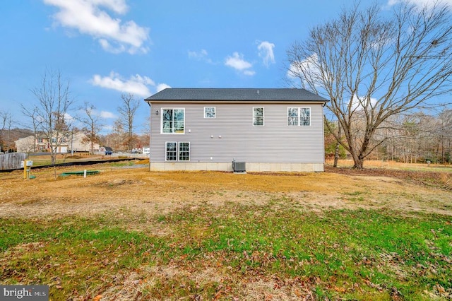 rear view of property with central AC unit