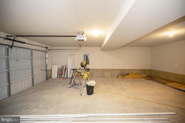 garage featuring electric panel and a garage door opener