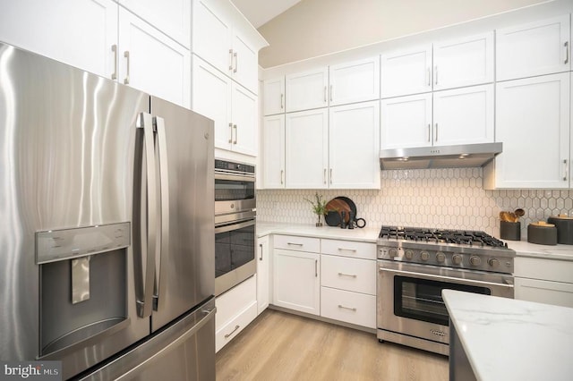 kitchen with decorative backsplash, white cabinetry, and stainless steel appliances