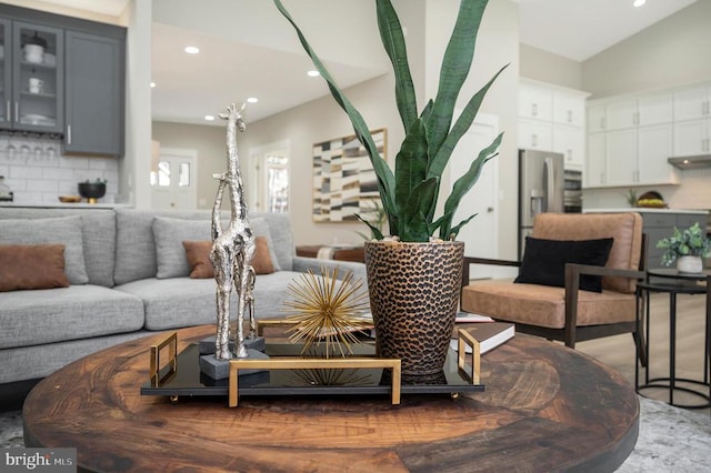 living room featuring lofted ceiling