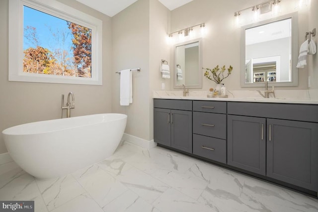 bathroom with vanity and a tub