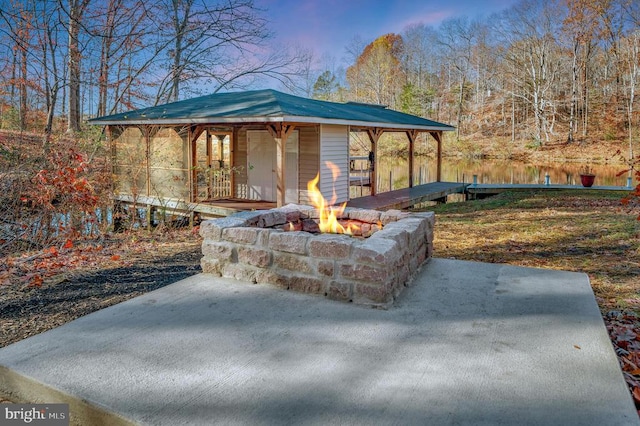 view of patio / terrace with a water view and a fire pit