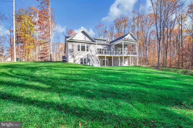 back of house featuring a lawn and a deck