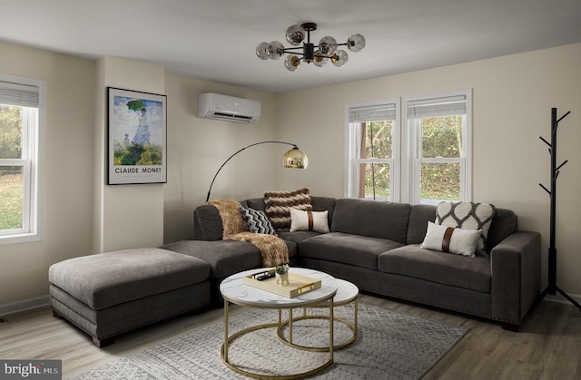 living room with a wall unit AC, a wealth of natural light, and hardwood / wood-style flooring