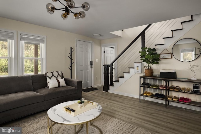 living room with hardwood / wood-style flooring and a notable chandelier