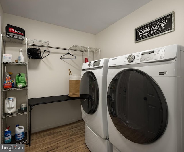 laundry room featuring independent washer and dryer and hardwood / wood-style flooring