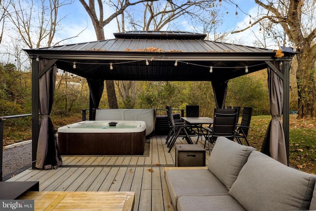 wooden terrace with outdoor lounge area, a gazebo, and a hot tub