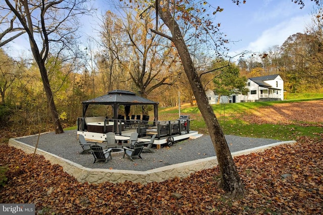 view of patio featuring a gazebo and a fire pit