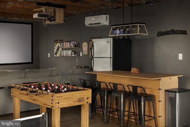 playroom featuring wood-type flooring and a wall mounted AC