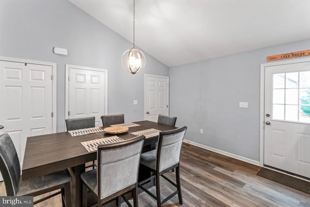 dining area featuring dark hardwood / wood-style floors and high vaulted ceiling