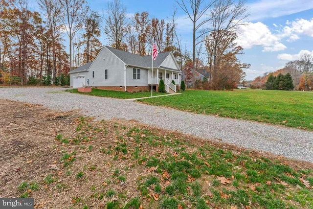 view of side of property with a garage and a lawn