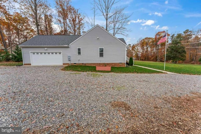 view of side of property with a yard and a garage