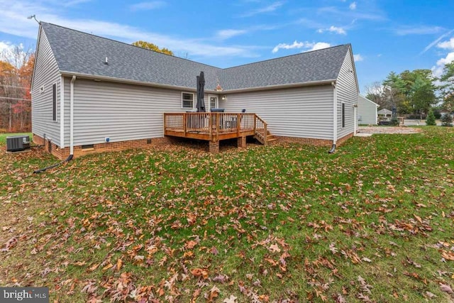 back of property featuring a deck, cooling unit, and a lawn