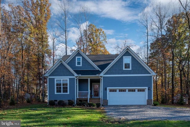 view of front of home with covered porch, a garage, and a front yard