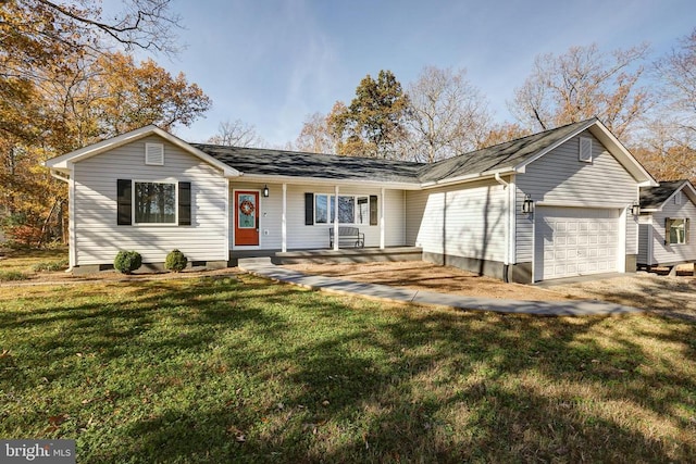 ranch-style house with covered porch, a garage, and a front yard