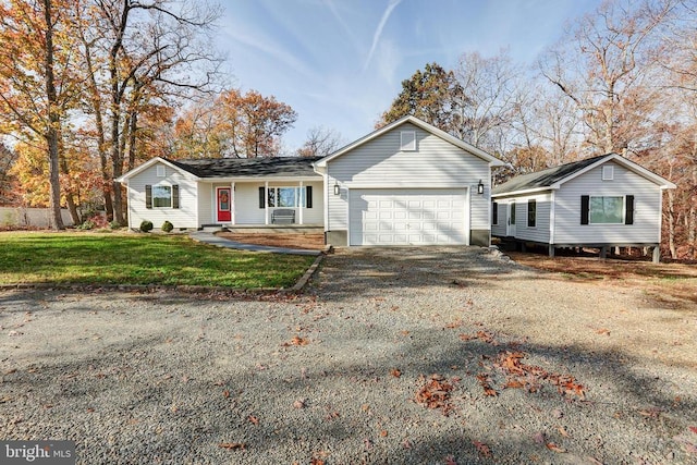 single story home featuring a front lawn and a garage