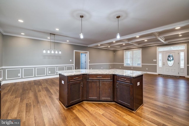 kitchen featuring pendant lighting, hardwood / wood-style flooring, and a kitchen island