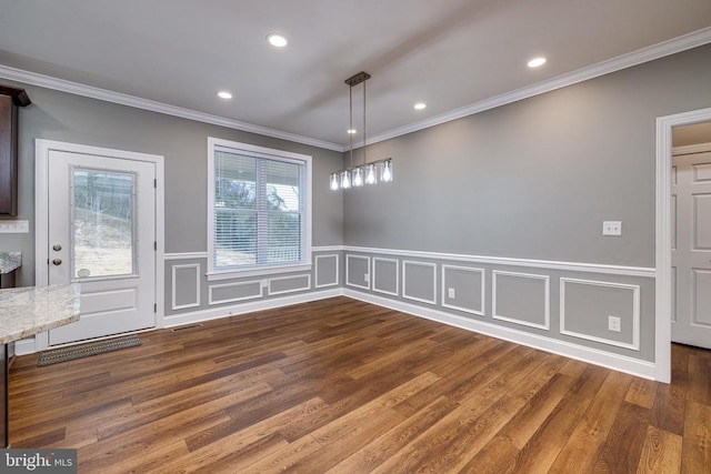 unfurnished dining area with crown molding and wood-type flooring