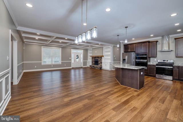 kitchen with hanging light fixtures, wall chimney exhaust hood, stainless steel appliances, and dark hardwood / wood-style floors