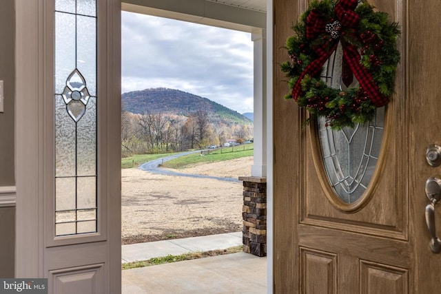 entrance foyer with a mountain view and carpet floors