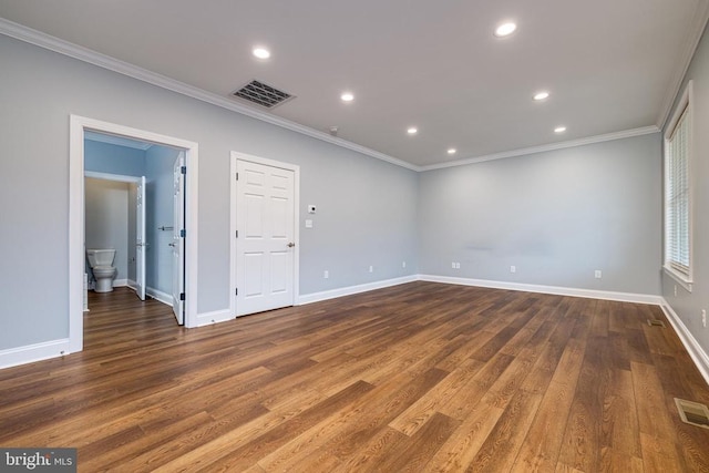 unfurnished room with crown molding and dark wood-type flooring