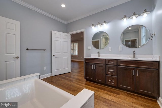 bathroom featuring hardwood / wood-style flooring, vanity, and ornamental molding