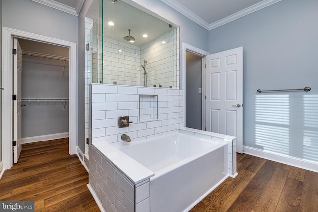 bathroom featuring plus walk in shower, wood-type flooring, and ornamental molding