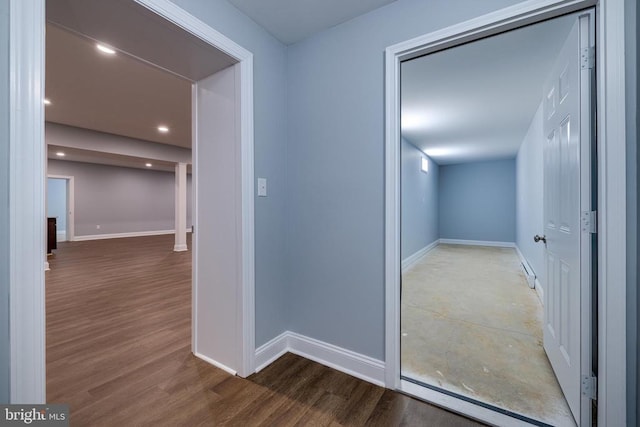 hallway with hardwood / wood-style flooring