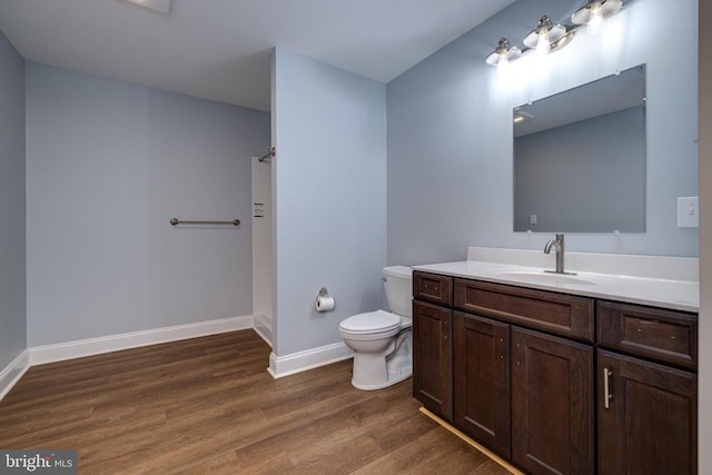 bathroom featuring wood-type flooring, vanity, and toilet