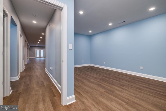 corridor with dark hardwood / wood-style floors